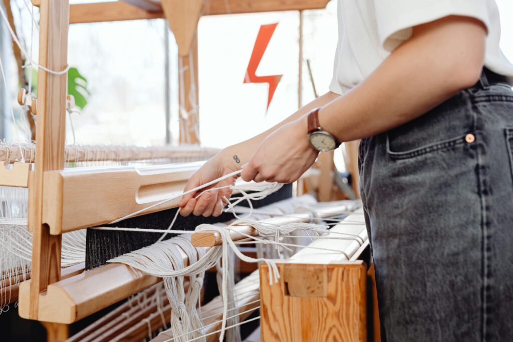 woman weving on traditional machine