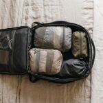 Open carry-on backpack with compression cubes and a one-week minimalist packing list
