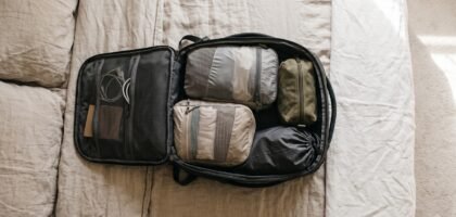 Open carry-on backpack with compression cubes and a one-week minimalist packing list