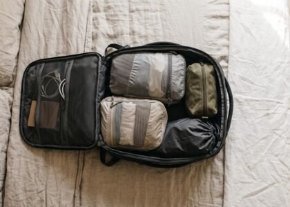 Open carry-on backpack with compression cubes and a one-week minimalist packing list